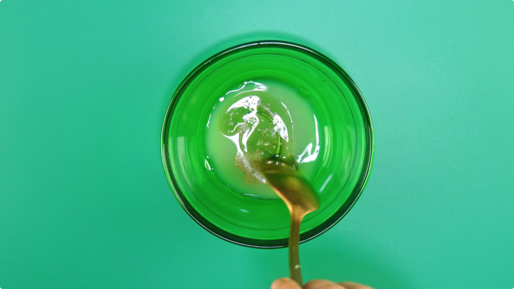 Stirring a dressing of lime juice and oilive oil in a glass dish